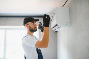 Repairman fix air conditioning systems, Male technicians service for repair and maintenance of air conditioners, Air conditioning technicians install new air conditioners in homes